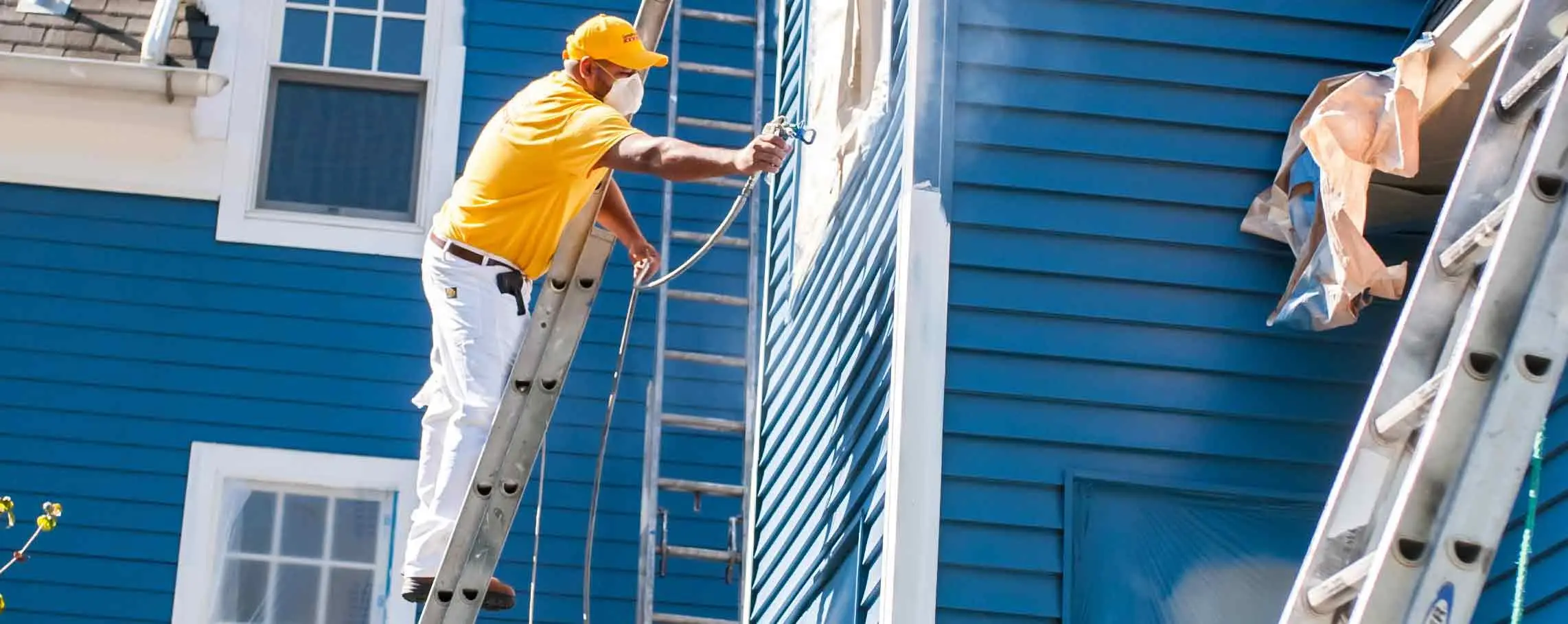 Exterior painting on a coastal home in Wakefield Rhode Island with detailed trim and siding
