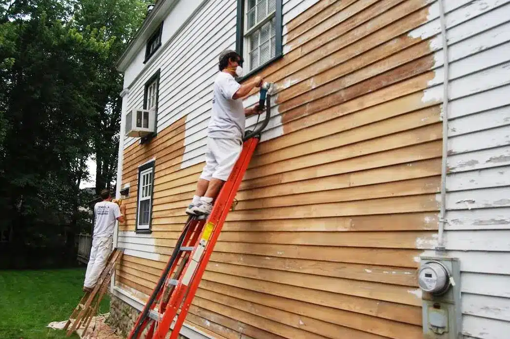 Exterior house painting preparation process including sanding, cleaning, and priming for long-lasting results